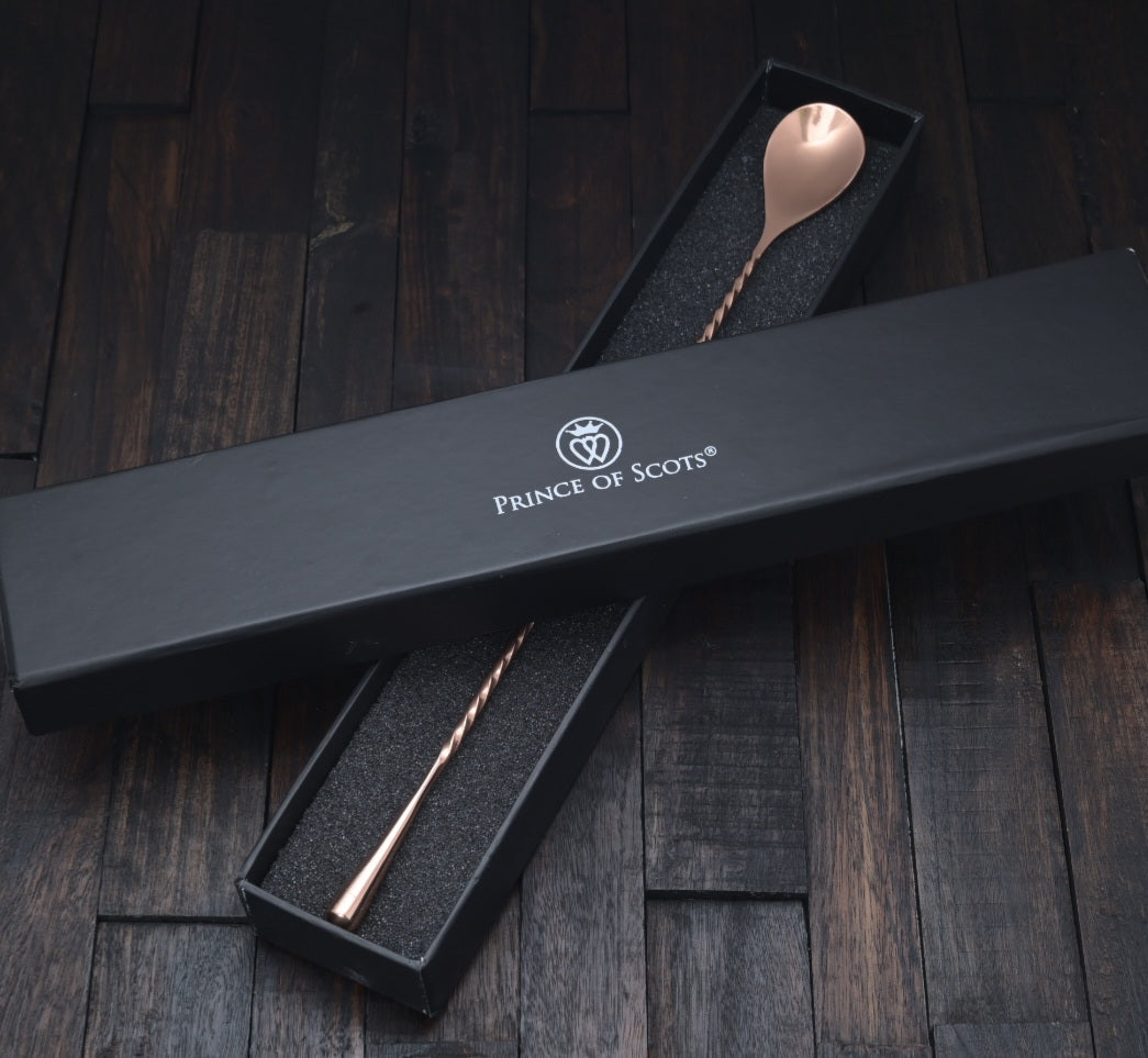 Japanese-style copper cocktail bar spoon with a twisted handle and teardrop end in a black gift box.