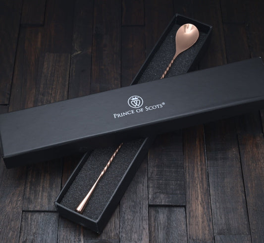 Japanese-style copper cocktail bar spoon with a twisted handle and teardrop end in a black gift box.